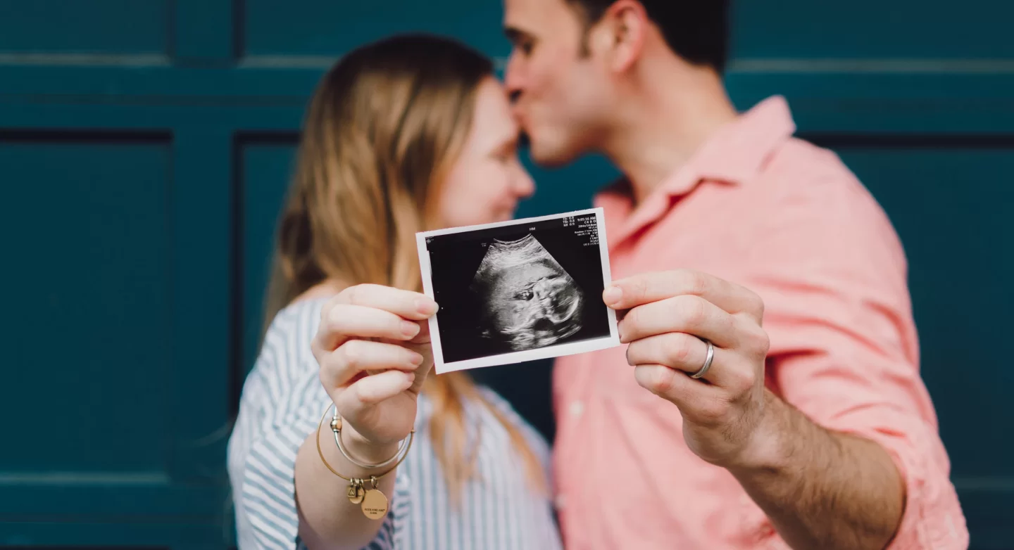 Hopeful parents holding an ultrasound scan